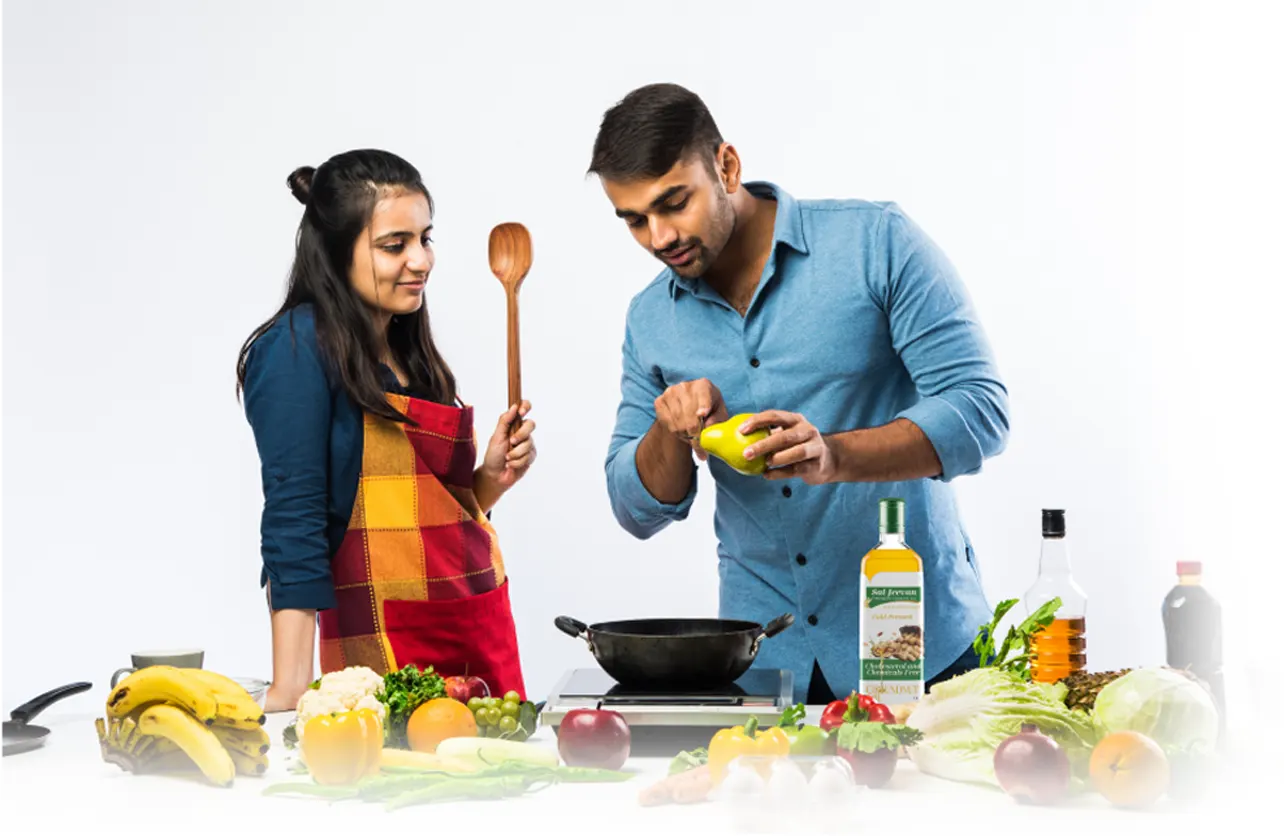 Couple cooking with Sai Jeevan oil